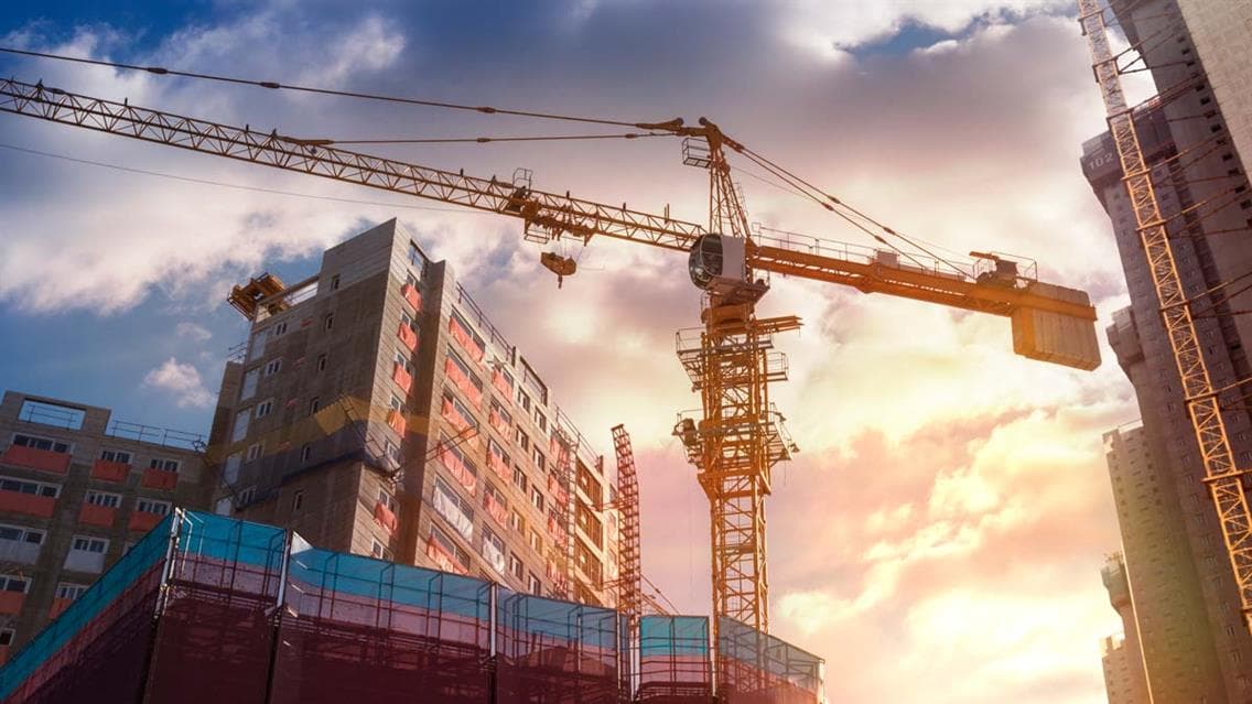 A crane in front of a skyscraper