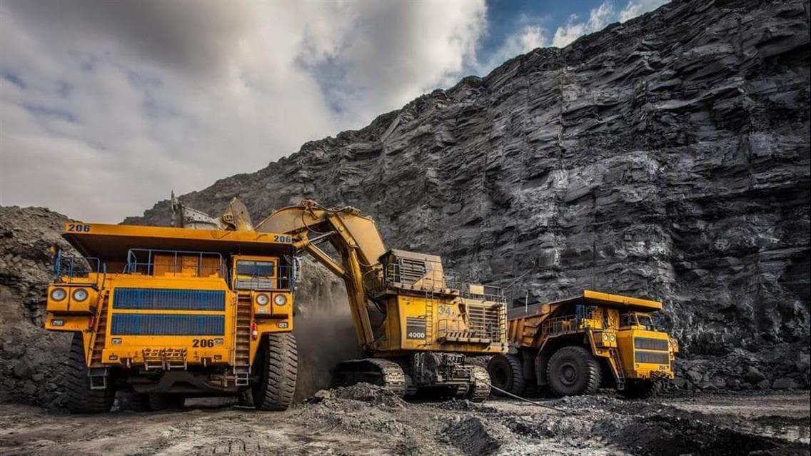 Large yellow mining trucks and equipment in a mine